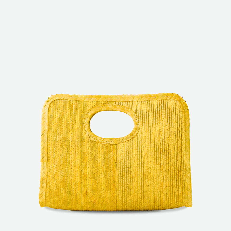 Mini square handheld straw tote in yellow, woven from palm and dyed with organic colors. Summer-ready design by Per Lei New York.