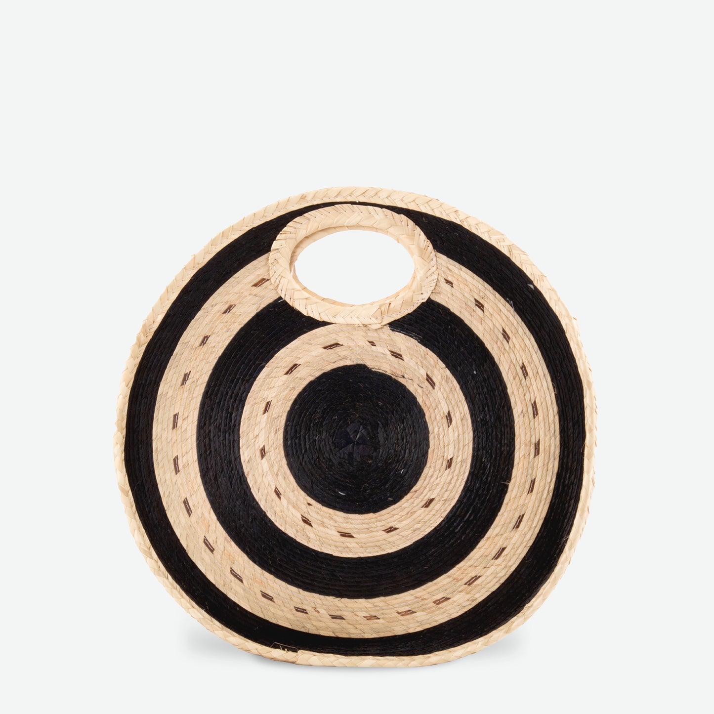 Round straw beach tote in black and natural woven from palm and dyed with organic colors. Summer-ready design by Per Lei New York.