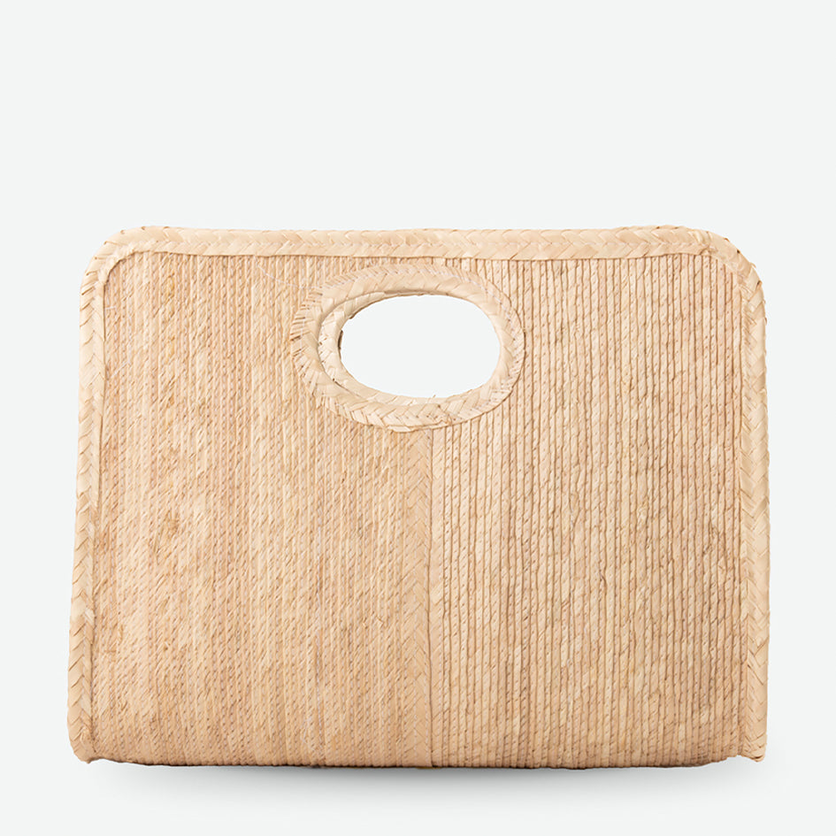 Beige woven clutch bag with a circular handle on a light gray background